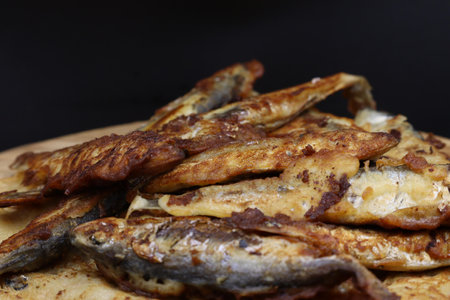 A wooden plate filled with fried sprats or capelin.の写真素材