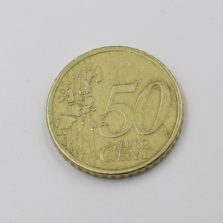 A golden 50 cent euro coin placed on a white background.の写真素材
