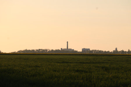 A rural landscape with distant buildings at sunset.の写真素材