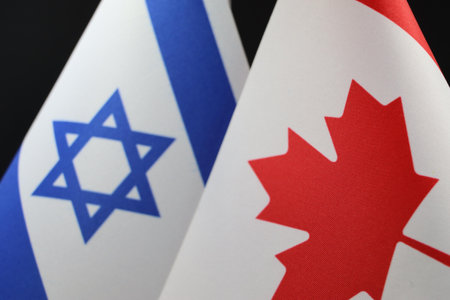 The Israeli and Canadian flags displayed together.の写真素材