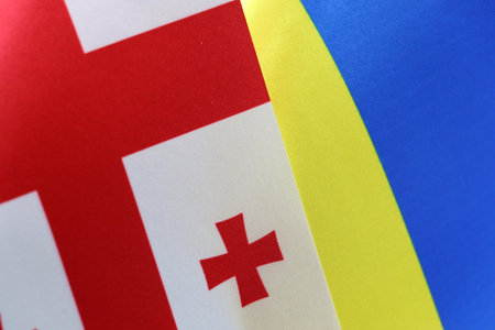 Close-up of the Georgian and Ukrainian flags side by side. A symbol of international unity.