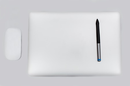 Closed notebook and All with isolated screen on table.の写真素材