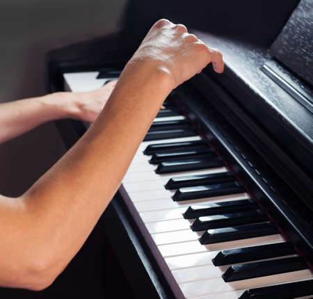 Unrecognizable young caucasian female plays the pianoの写真素材