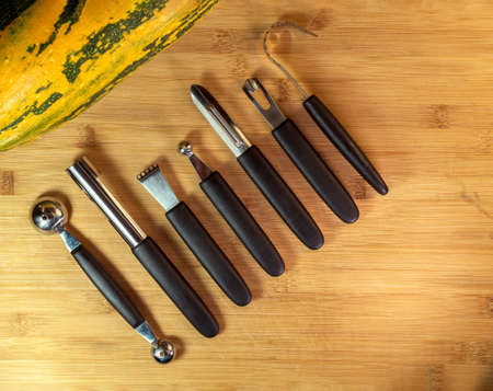 A tools kit for vegetable carving on the wood background.