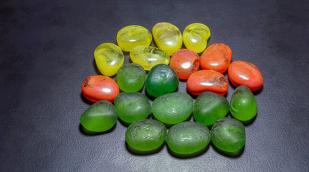 The colorful polished semi-precious pebbles on the dark background. Close up.の写真素材