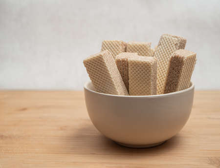 A bowl of a neapolitan waffles on a wooden table. Close-up.の写真素材