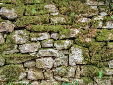 Ancient wall masonry from chipped granite blocks. Wall stone pattern.