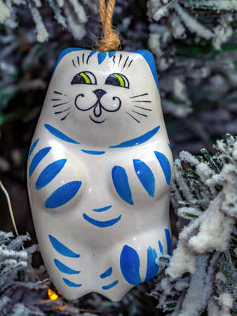 The x-mas tree toy is hanging on the Christmas tree. A blue tiger as the symbol of 2022.の写真素材