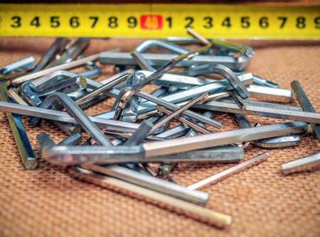 Chaotic mess of hex keys. Heap of the iron instruments. Close-up
