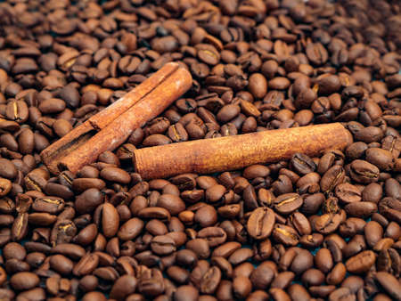 Background of the coffee beans and cinnamon sticks. close-up