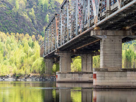 Old abandoned railway bridge across the river.の写真素材