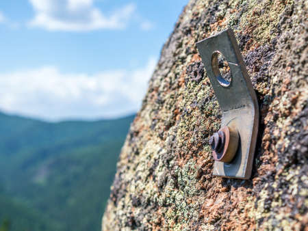 Rock climbing python (also called a pin or peg) on the stone rock. Close up, selective focusの写真素材