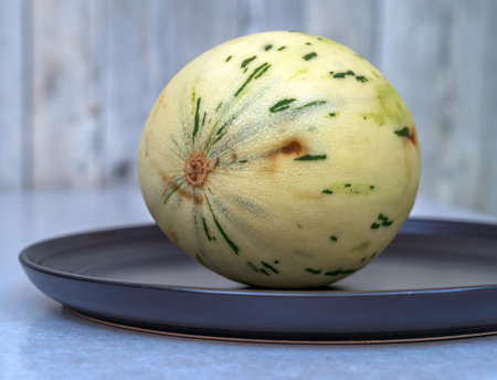 Dalmatian melon in the dark plate. Dalmatian melon is a new japan hybrid low calorie melon....