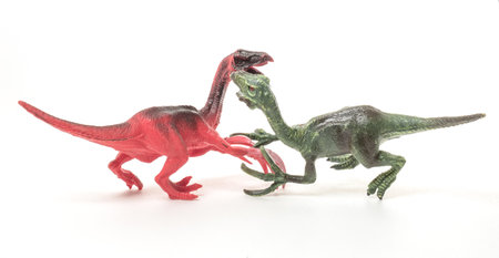 Buttle of modeles of Therizinosaurus. Dinosaur isolated on the white background. close-up