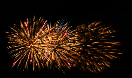 Multiple fireworks against the deep black sky. Bright display of the fireworksの写真素材