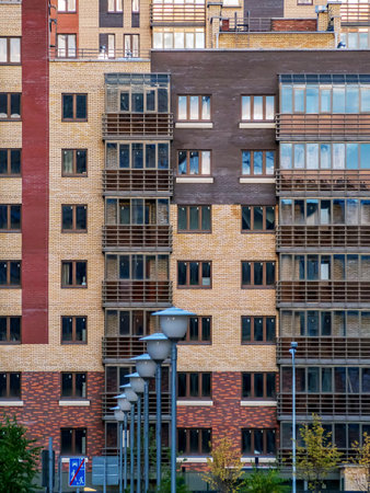 Large number of windows and balconies on building facade. Apartment block Residential building, residential areaの写真素材