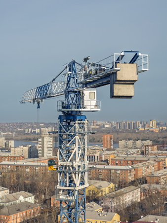 The upper part of the tower crane with the crane operator's cabinの写真素材