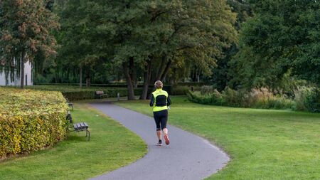 VIBORG, DENMARK -  SEPTEMBER 17, 2016: An unidentified woman running in Viborg, Denmark.