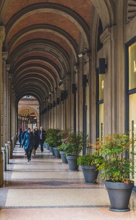 BOLOGNA, ITALY - 17 FEBRUARY, 2016: People Walking through a Portico, sheltered walkway, in Bologna with its almost 40 kilometres of porticos. Bologna is a unique city in the world.のeditorial素材
