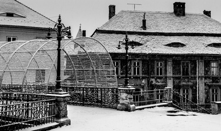 the bridge of lies in sibiu and old historic buildings covered in snow in Sibiu, Romania.