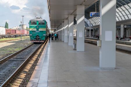 CHISINAU, MOLDOVA - 11 MAY, 2016: A train with people boarding at the Central Train Station in Chisinau.のeditorial素材