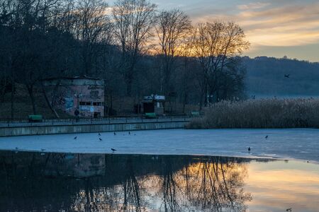 CHISINAU, MOLDOVA - 26 DECEMBER, 2016: View to the lake during dawn with some ice on itのeditorial素材