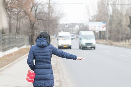 CHISINAU, MOLDOVA - 3 JANUARY, 2017: A lady trying to stop a minibus with the usual sign in Chisinau- by lifting an arm.のeditorial素材