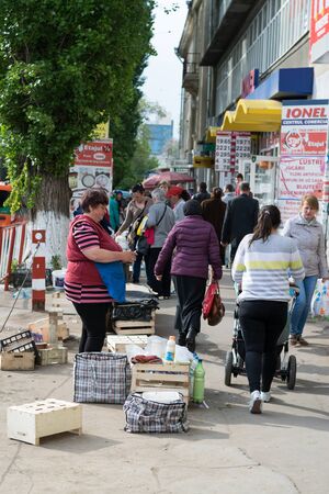 CHISINAU, MOLDOVA -29 APRIL: A lady selling  some diary products at the Central Market in Chisinau.のeditorial素材