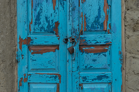A locker for two old blue doors in a village area in Moldova.の写真素材
