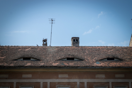 The roof eyes of a red building in Sibiu.の写真素材