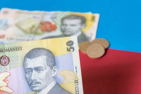 Romanian banknotes on a blue and red background. Coloseup of RON, Romanian Currency. Romanian RON,...