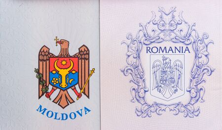 Dual citizenship concept. The Romanian and Moldovan passport. Coloseup of Romanian and Moldovan passport. Multiple citizenships, dual citizenship, multiple nationalities or dual nationality concept.の写真素材