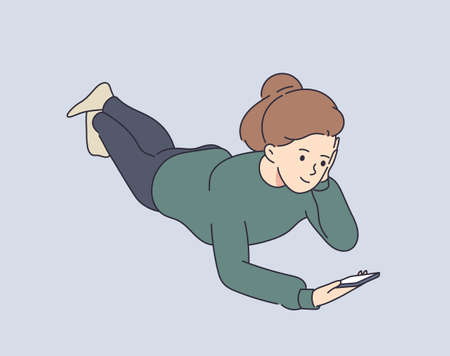 Communication, comfort, smart. Young smiling attractive girl using a smartphone writes or speaks at home after school.のイラスト素材