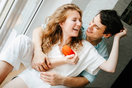 Couple in love watches a gift heart box on Valentines day.の写真素材
