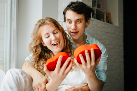 Couple in love watches a gift heart box on Valentines day.の写真素材