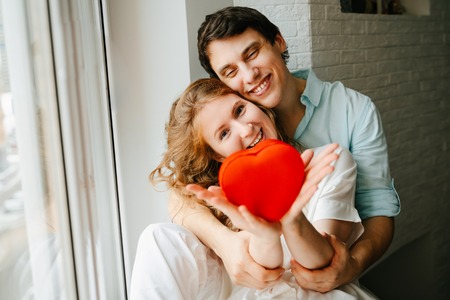 Couple in love watches a gift heart box on Valentines day holiday.の写真素材