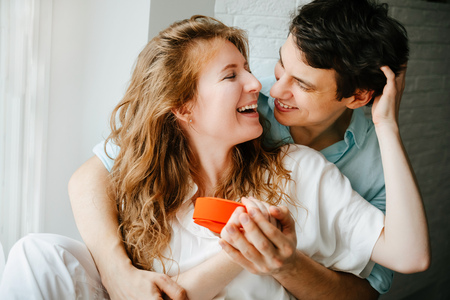 Couple in love watches a gift heart box on Valentines day holiday.の写真素材