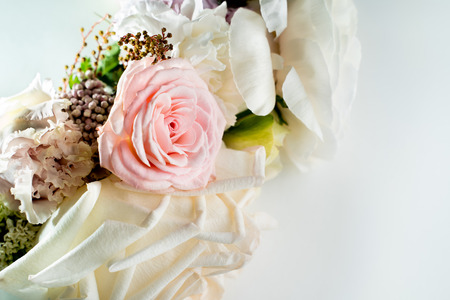 Bouquet of white roses lying on the white table.の写真素材