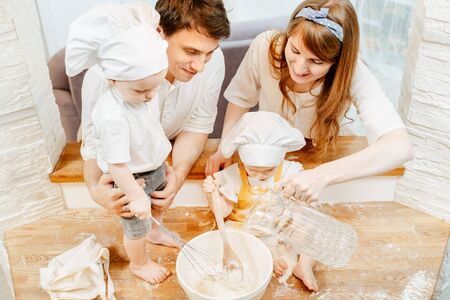 Top view of cute positive parents in white cap