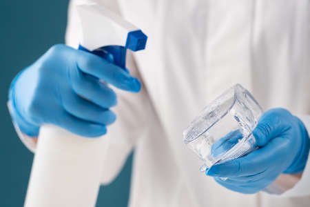 Disinfection of goggles by a nurse with an antiseptic against viruses and bacteria.の写真素材