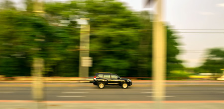 passenger car traveling at high speed on the roadの写真素材