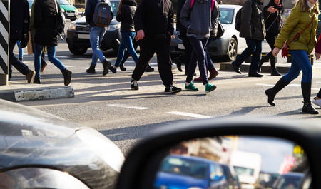 Pedestrians cross the street on a pedestrian crossingの写真素材