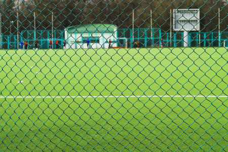 Football field behind the fenceの写真素材