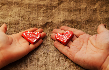 Two hearts on a female and man's palmsの写真素材