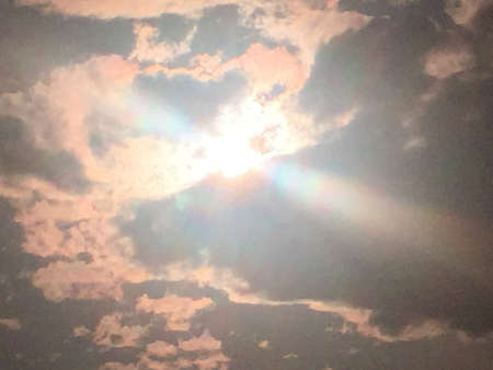 The sun's rays through the cloud, through a light filter.