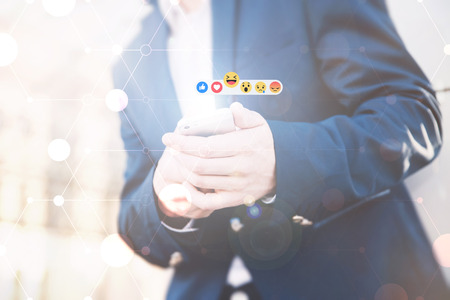 Communication in social networks. A stylish guy in a jacket expresses his emotions and evaluates...