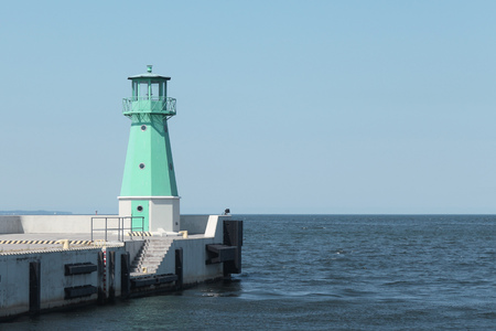 Lighthouse on with a clear sky and calm sea. Photo of an amazing nature.の写真素材