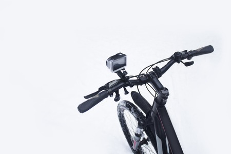 Action camera on a bicycle in a protective case in the winter on a snowの写真素材