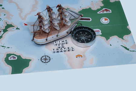 Time to Travel. Idea for tourism with sailing ship, compass and map. Concept on the theme of flightsの写真素材