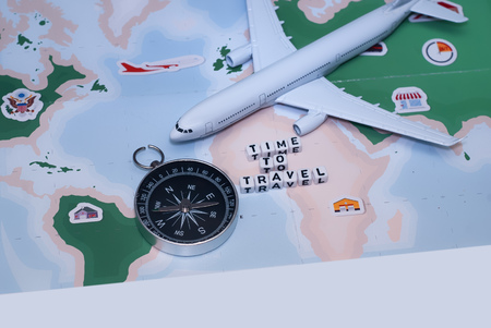 Time to Travel. Idea for tourism with airplane, compass and map on a light background. Concept on...